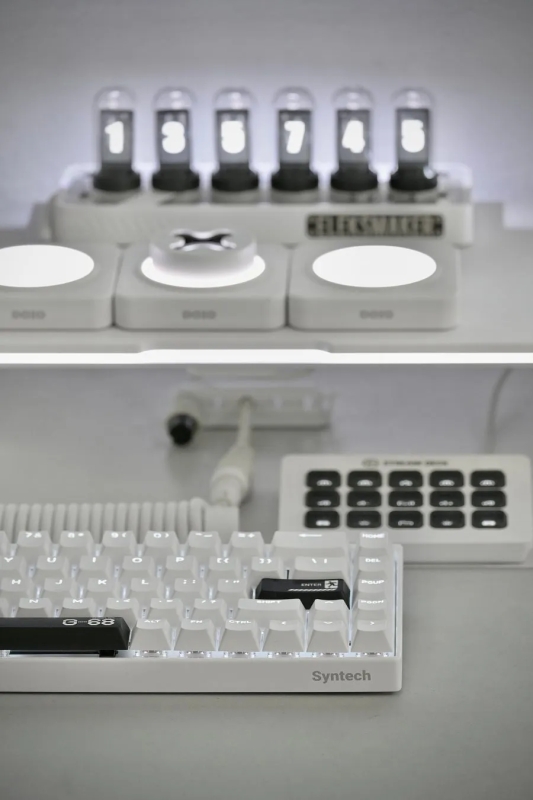 白いキーボード、数値が表示されたディスプレイ、複数のボタンを備えたデバイスが写っています。キーボードには Syntech のロゴが、ディスプレイには Helixmaker の文字が確認できます。